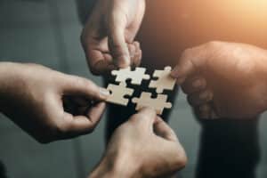 mobile jigsaw puzzle pieces business cooperation concept teamwork and cooperation Businessmen join a jigsaw team, charity, volunteerism, unity, teamwork.