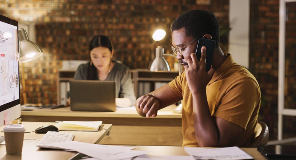 Time, late and a man on a phone call at work for business